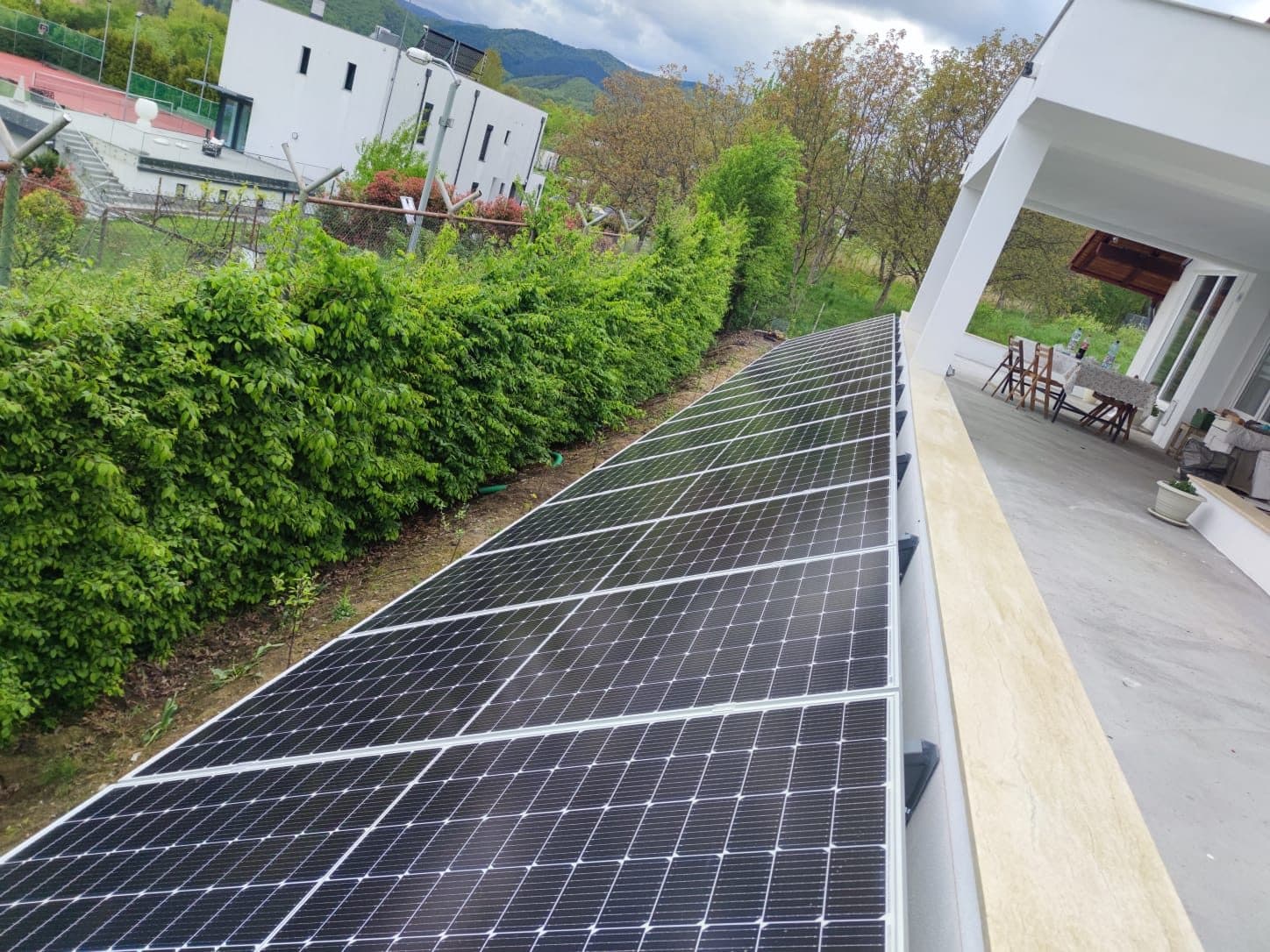 Solar panels on an inclined structure beside a house terrace in Cisnădioara, Sibiu